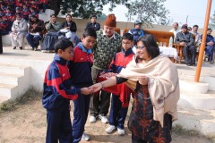 Mrs-Shelly-Sen-giving-sweets-to-the-students-on-Makar-Sankrati